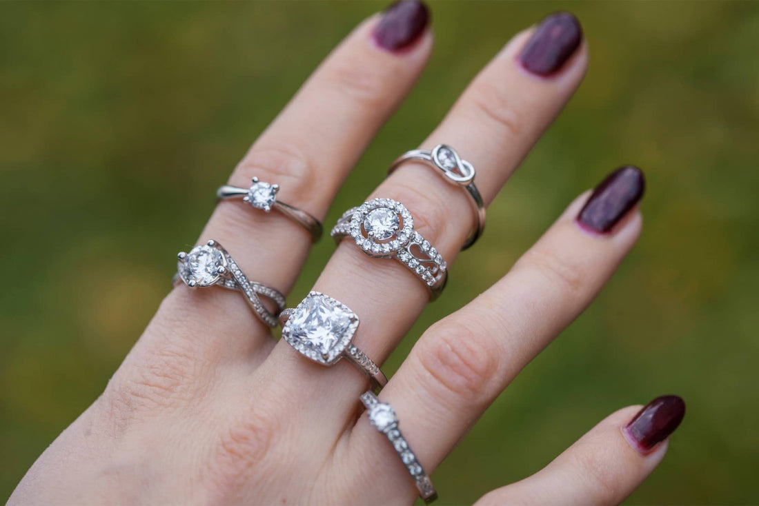 Photo of hand wearing multiple diamond engagement rings